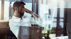 man with palm in face under stress