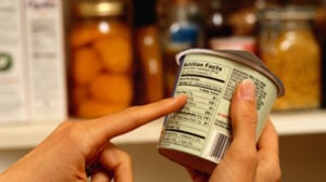 a person checking food label to make sure ingredients are healthy.